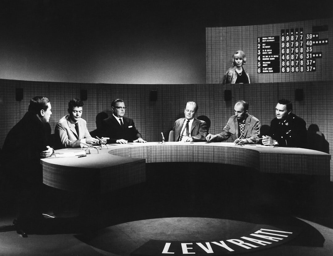 Modern newsroom with journalists working at computers
